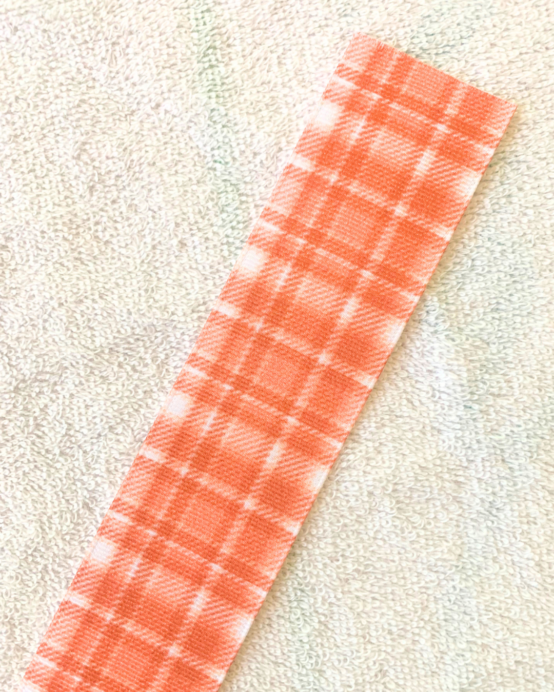 Orange plaid design hair ribbon. 