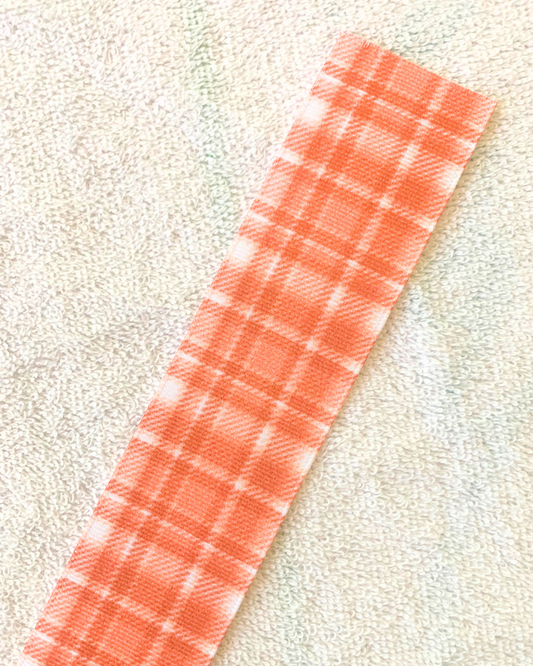Orange plaid design hair ribbon. 