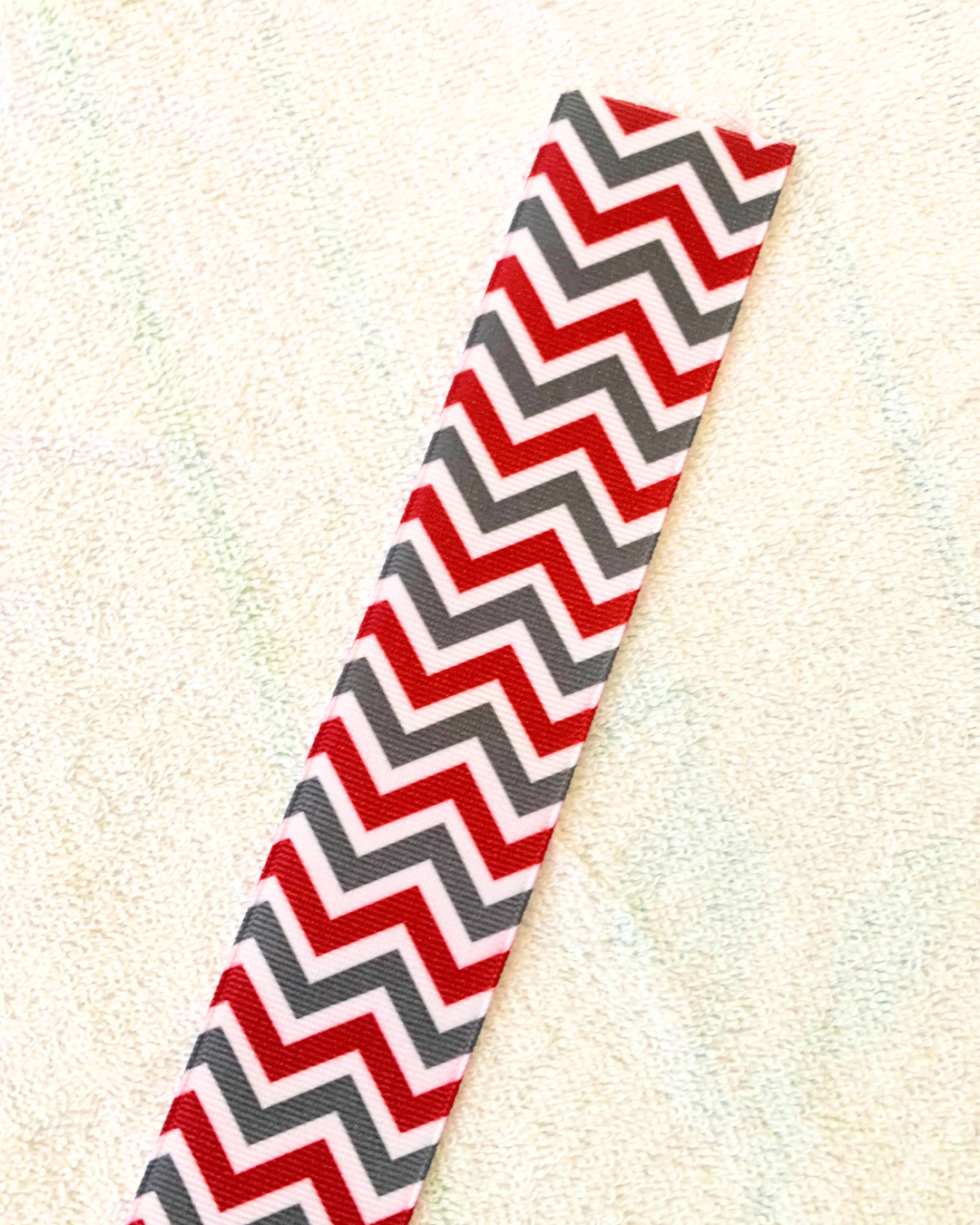 Embroidered red and green zig zag stripes design hair ribbon.