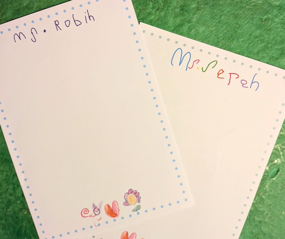 5x7 white notepad with your little one's hand drawings. Dotted border around notepad. 